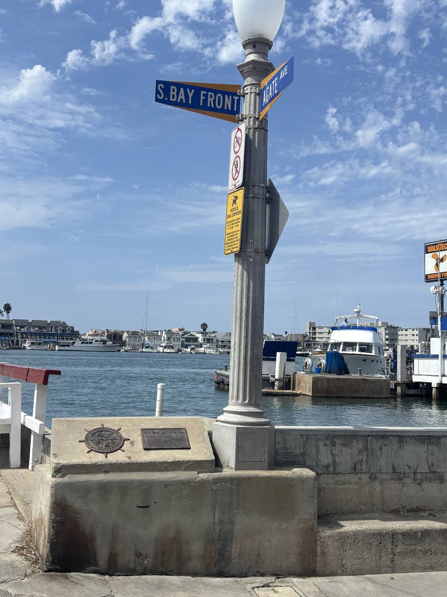 South Bay Front street sign with the harbor behind it