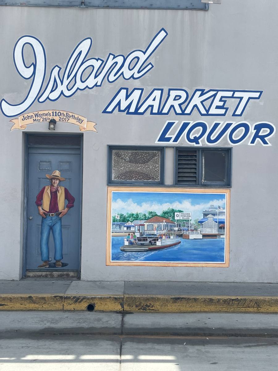 The painted Island Market Liquor mural on the side of the building