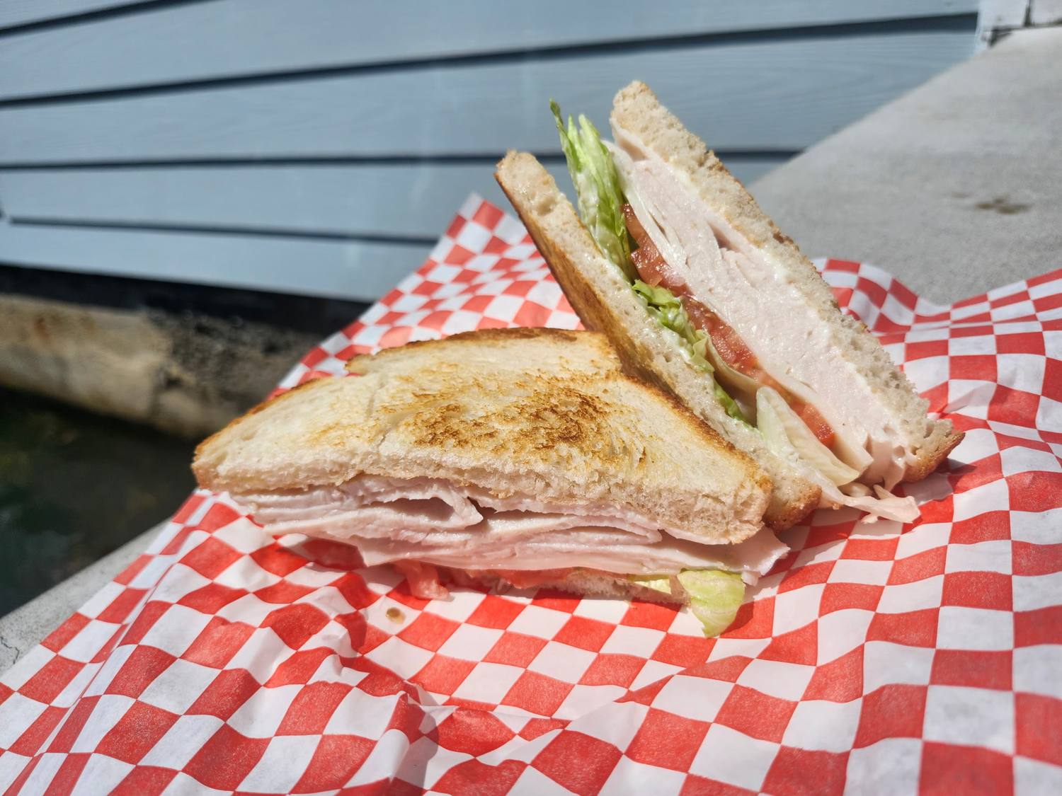 Turkey sandwich with lettuce and tomato on toasted bread